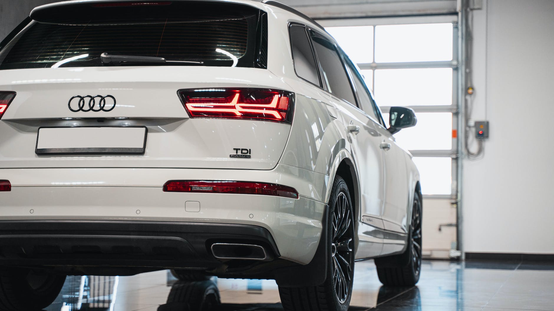 a white audi car parked in a garage